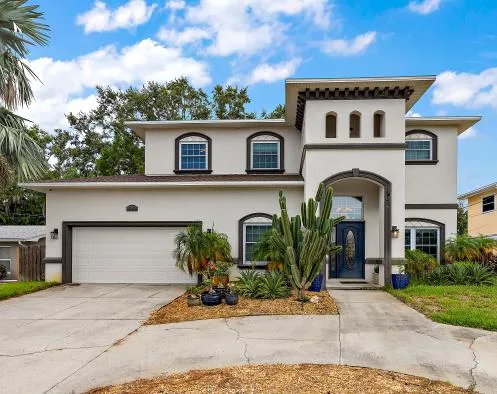 A two-story home with a landscaped front entrance